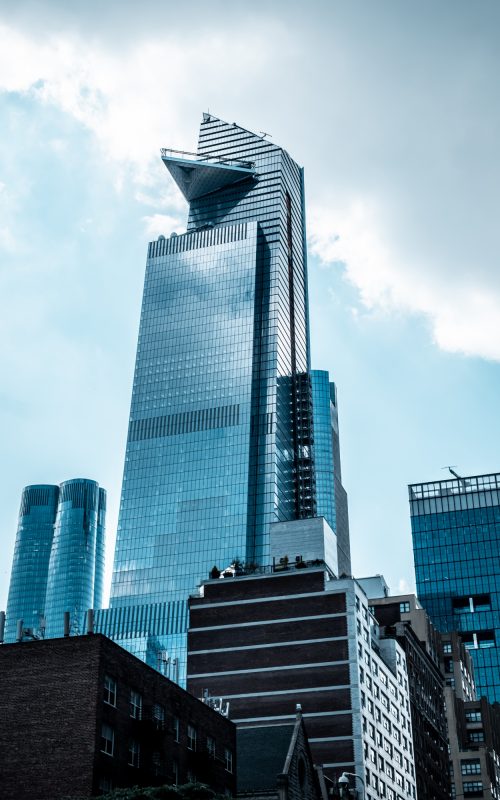 vertical-low-angle-shot-modern-glass-business-buildings-touching-sky